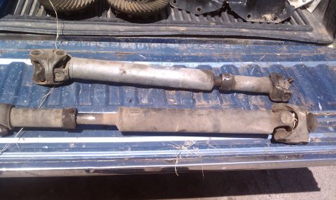 1979 Ford Bronco - Two driveshafts and differential gears are laid out in the bed of a truck.