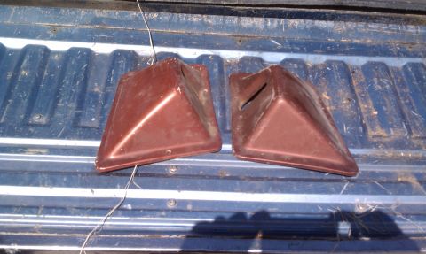 1979 Ford Bronco - Two brown plastic corner pieces with slots are shown resting on a blue truck bed.