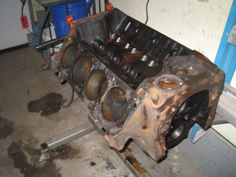 1979 Ford Bronco - A heavily used V8 engine block sits on a stand, showing signs of wear and tear.