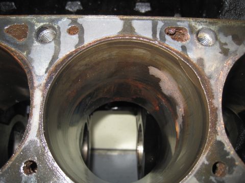 1979 Ford Bronco - Close-up view of engine block cylinders showing signs of rust and water damage.