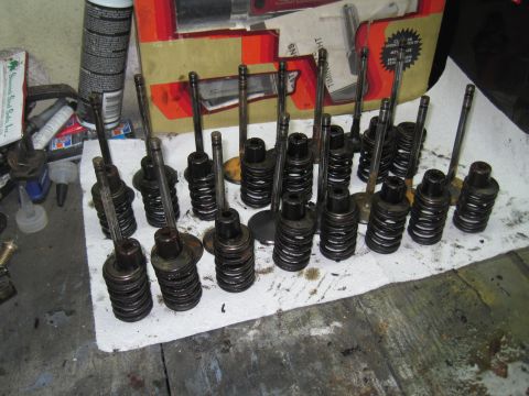 1979 Ford Bronco - Engine valves and springs are organized on a cloth, with a box of timing components visible behind them.