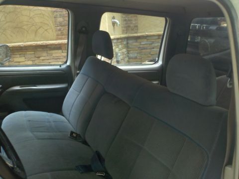 1997 Ford F-350 - The interior of a truck, cloth seats and a view of the exterior through the windows.