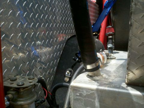 1979 Ford Bronco - Custom fuel system components are visible, including a fuel filter and hoses connected to a metal tank.