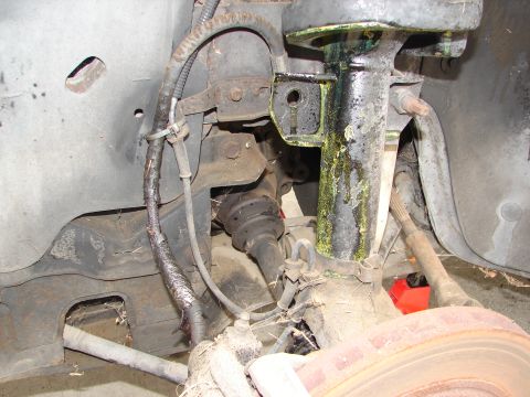 1992 Ford Taurus - Front suspension components including strut, brake rotor, and drive axle boot are visible in this close-up.