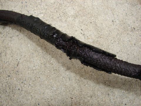 1992 Ford Taurus - A close-up view of a damaged wire harness, showing frayed insulation and exposed wires.