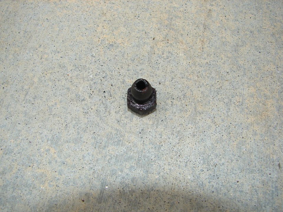 Black brake line fitting on concrete