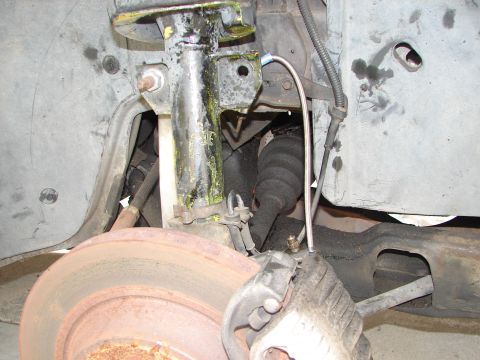 1992 Ford Taurus - This image shows the brake and suspension system of a vehicle, including a shock absorber and brake rotor.
