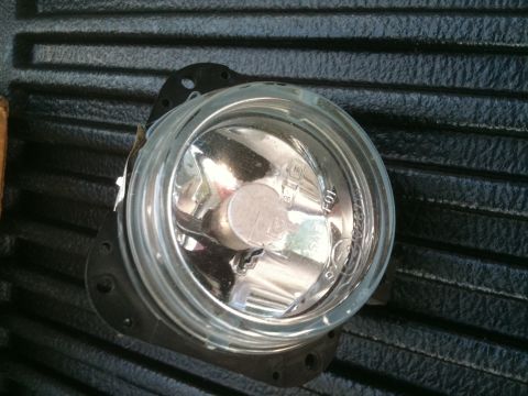 1993 Ford Crown Victoria - Close-up of a single fog light assembly, showing the clear lens and mounting hardware.