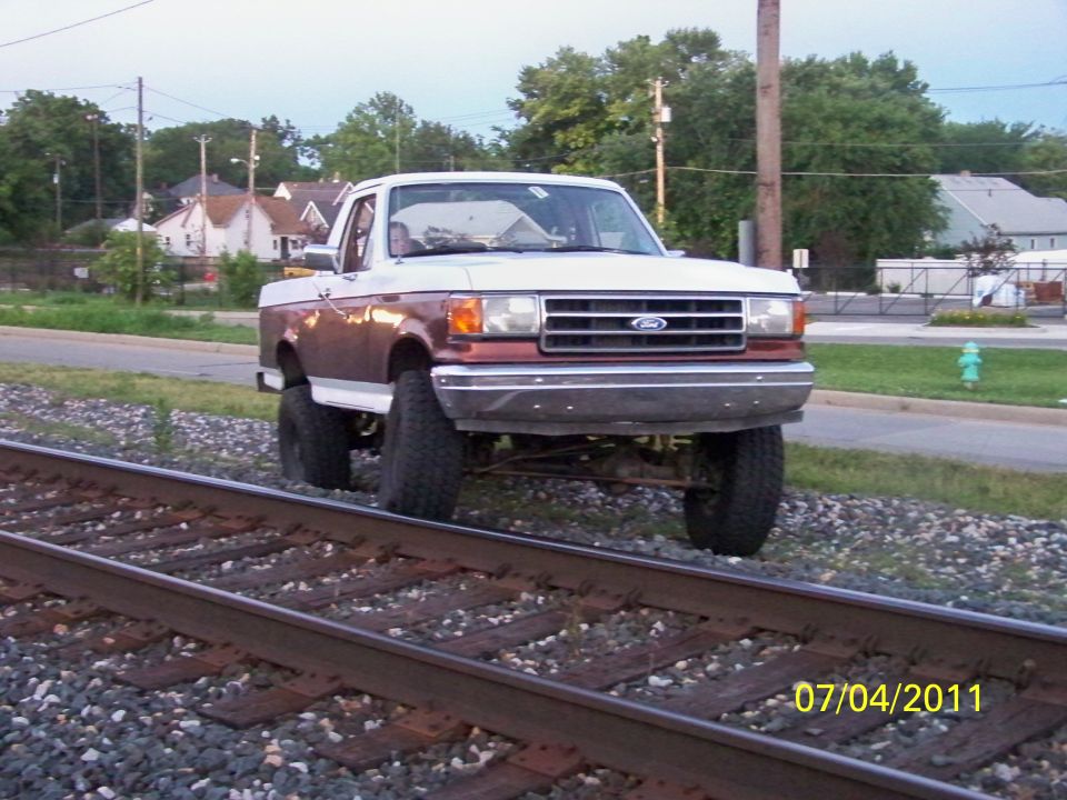 Ford F-Series truck on railroad tracks. Date stamp reads 07/04/2011
