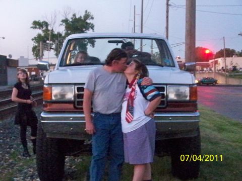 1989 Ford Bronco - A couple shares a kiss in front of a lifted white Ford Bronco, with a date stamp of 07/04/2011.