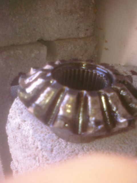 1995 Ford Bronco - A close-up view of a differential gear, a component of a vehicle's drivetrain.