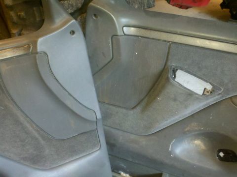 2005 Ford F-250 - Two interior door panels are shown, with visible wear and tear. A watermark for Supermotors.net is present.