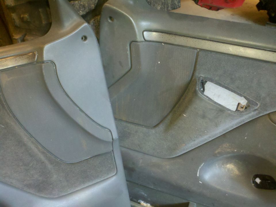 Close-up of two gray vehicle door panels, one on the left and one on the right