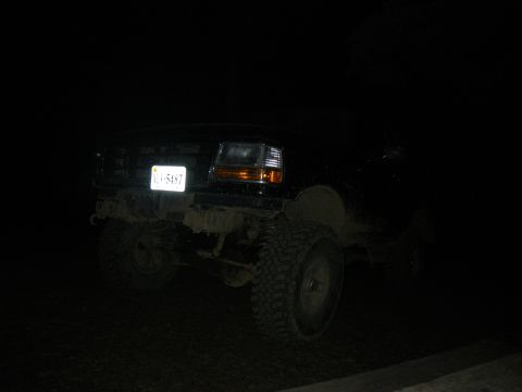 1995 Ford Bronco - Front view of a 1995 Ford Bronco at night, license plate illuminated.