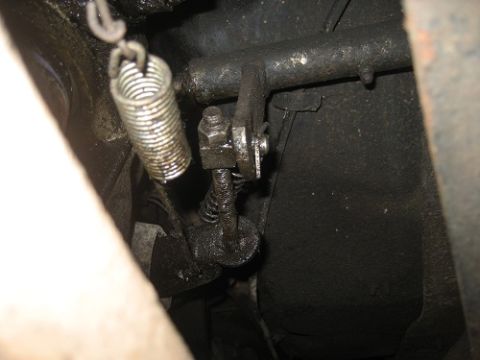 1983 Chevrolet C/K Pickup - Underside view of a vehicle's clutch linkage mechanism, showing a spring and rod.