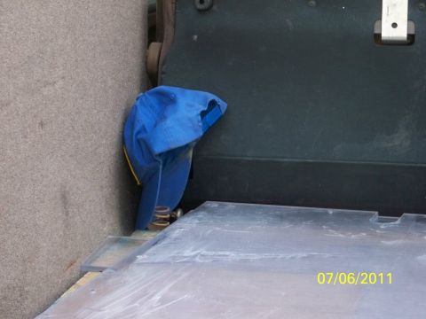 1989 Ford Bronco - A blue cap hangs from a spring, with a date stamp of 07/06/2011 visible on a surface.