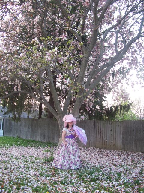 1989 Ford Bronco - A woman poses in a garden during springtime, surrounded by fallen petals from a flowering tree.