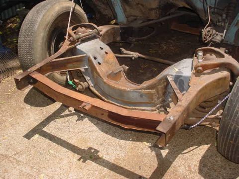 1953 Ford Mainline - Close-up view of a vehicle's rusty frame and suspension system.
