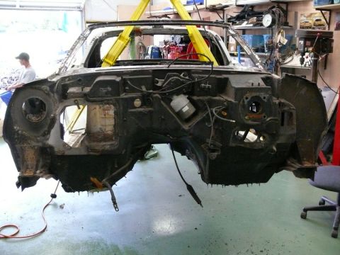 1976 Chevrolet Corvette - The front end of a 1976 Chevrolet Corvette is disassembled and suspended for repair.