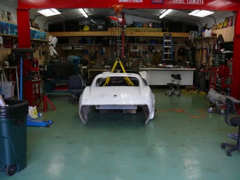 1976 Chevrolet Corvette - The rear of a 1976 Chevrolet Corvette, stripped down and suspended in a workshop for restoration.