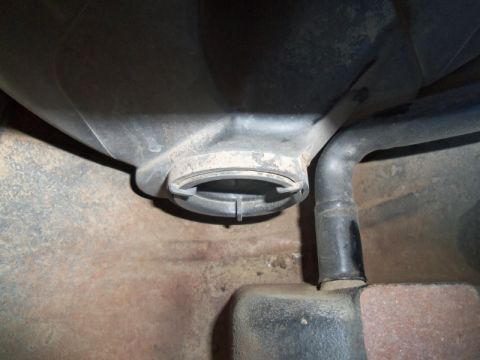 2000 Mercury Grand Marquis - Undercarriage view of a vehicle's fuel system components, including the filler neck and a hose.