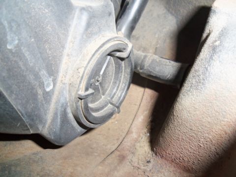 2000 Mercury Grand Marquis - A close-up view of a vehicle's headlight assembly cover, showing dust accumulation.