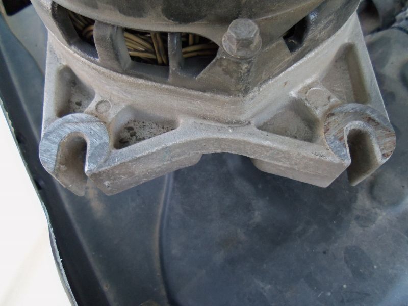 Close-up of an alternator mounting bracket with visible wiring