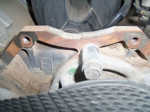 2000 Mercury Grand Marquis - Engine component with visible casting marks and a bolt, likely from a vehicle.