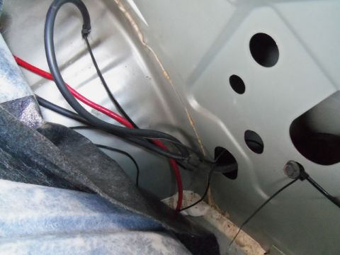2000 Mercury Grand Marquis - View of a vehicle's internal wiring harness, showing multiple cables and insulation.