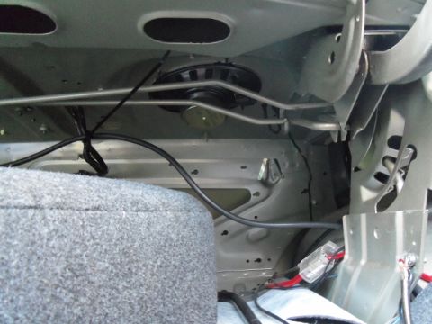 2000 Mercury Grand Marquis - Close-up view of a speaker and wiring located in the interior of a vehicle, with visible SuperMotors branding at the bottom.