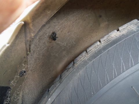2000 Mercury Grand Marquis - Interior of a vehicle's wheel well with a tire visible.