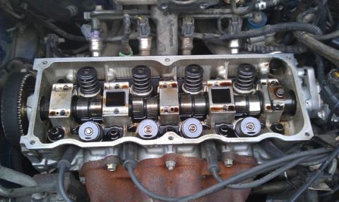 1991 Ford Festiva - Close-up view of an engine's internal components, including the camshaft and valves, with the valve cover removed.