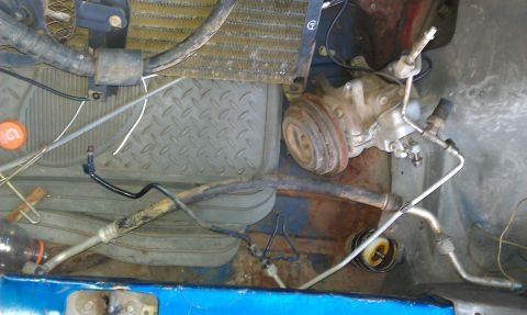 1991 Ford Festiva - Engine bay components including AC compressor and radiator are visible in this close-up view.