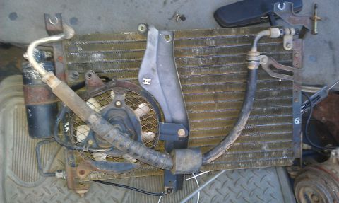 1991 Ford Festiva - A disassembled car radiator and fan assembly is shown, likely removed for repair or replacement.