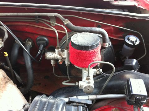 1990 Mazda Miata - Close-up of the brake fluid reservoir and master cylinder in a 1990 Mazda Miata.