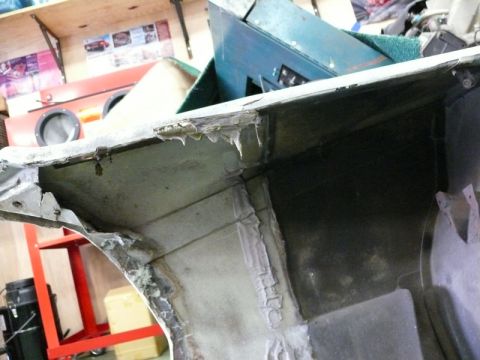 1976 Chevrolet Corvette - Close-up view of the interior of a damaged automotive part, showing wear and tear.