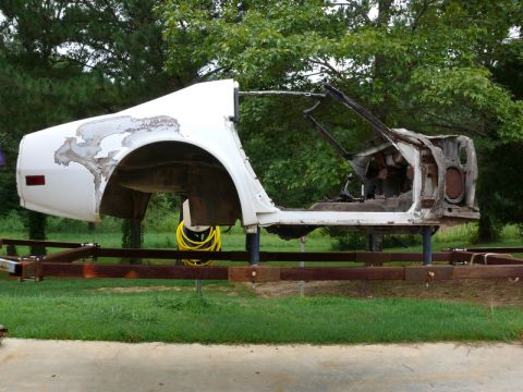 1976 Chevrolet Corvette - The body of a 1976 Chevrolet Corvette is shown on a trailer, undergoing restoration or repair.