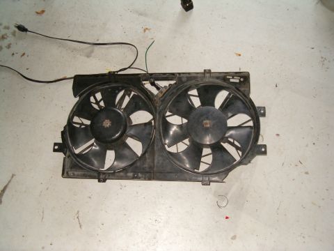 1991 Ford Bronco - A pair of black radiator fans with wiring is shown laid out on a concrete floor.
