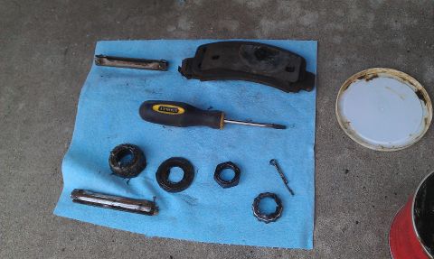 1992 Ford Ranger - Brake parts and tools are laid out on a blue shop towel, ready for maintenance.
