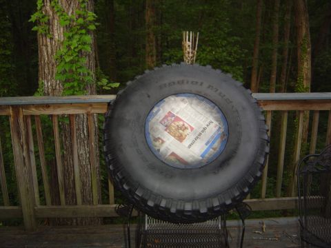 1986 Ford Bronco - A spare tire is displayed on a deck, with newspaper pages visible through the center.