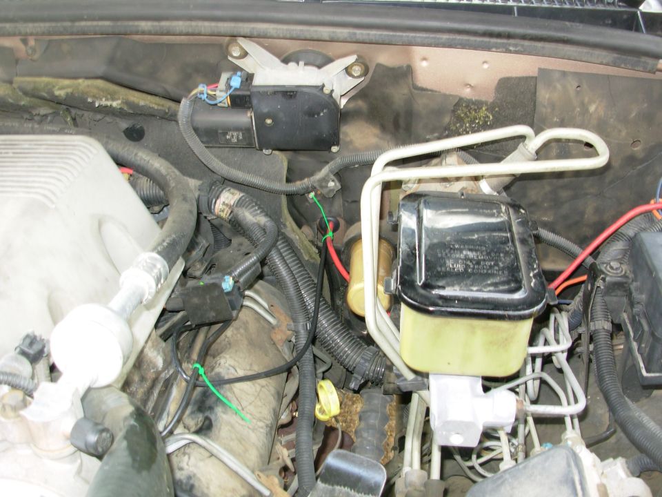 The big wires for the power inverter come through a stock firewall plug.  The ground goes to the L battery ground bolt on the intake, and the hot goes to a mega fuse under the hood hinge.  The fuse is large enough to add another inverter, or an amplifier, or...

I've tagged all the inverter wires with green zip-ties so anyone can ID & trace them later.
