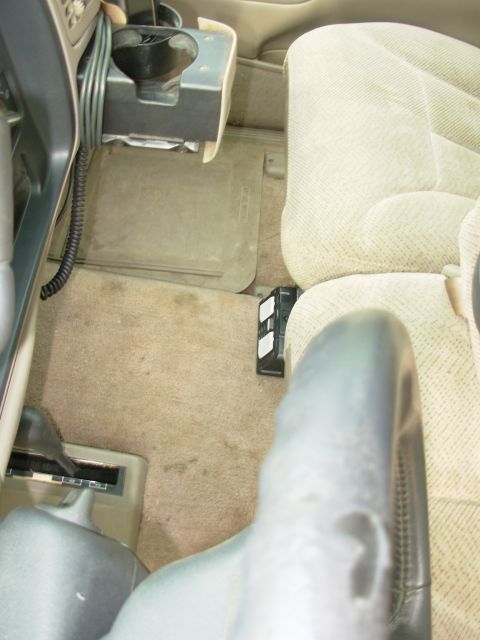 1997 Chevrolet Silverado 3500 - Even with the seats fully back, it's difficult to see, but VERY easy to access. The strap holding it down is only screwed to the carpet - n…