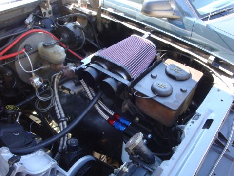 1989 Ford Bronco - The engine bay shows an aftermarket air intake system and other engine components.