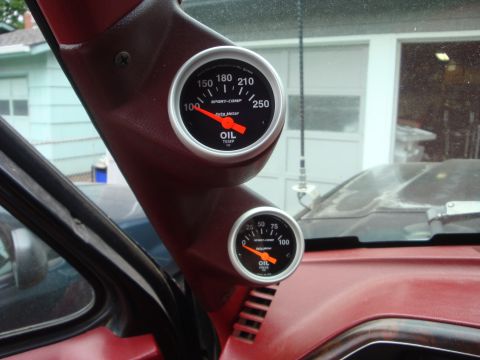 1989 Ford Bronco - Two Auto-Comp gauges, one for oil temperature and one for oil pressure, are visible inside the vehicle's interior.