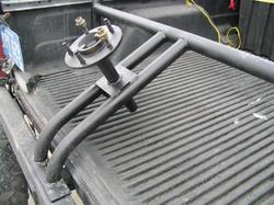 1987 Jeep Comanche - A custom spare tire mount is secured in the ribbed bed of a pickup truck.