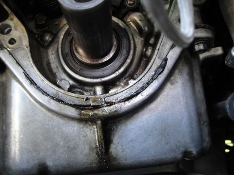1993 Ford Taurus - Close-up view of an engine component, revealing signs of oil leakage and gasket wear.