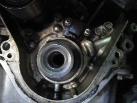 1993 Ford Taurus - Close-up view of an engine's timing cover assembly, showing mechanical components and a central pulley mechanism.