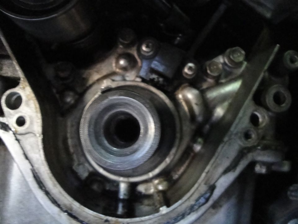 Engine timing cover assembly with a central pulley