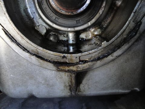 1993 Ford Taurus - This image shows a close-up of a mechanical component with visible oil residue and a potential leak.