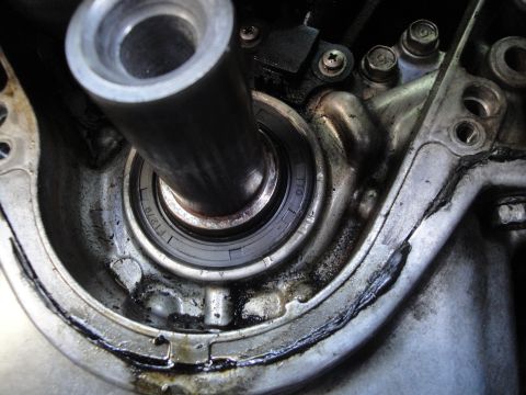 1993 Ford Taurus - A close-up view of a greasy engine component, showing a bearing and a metal shaft.
